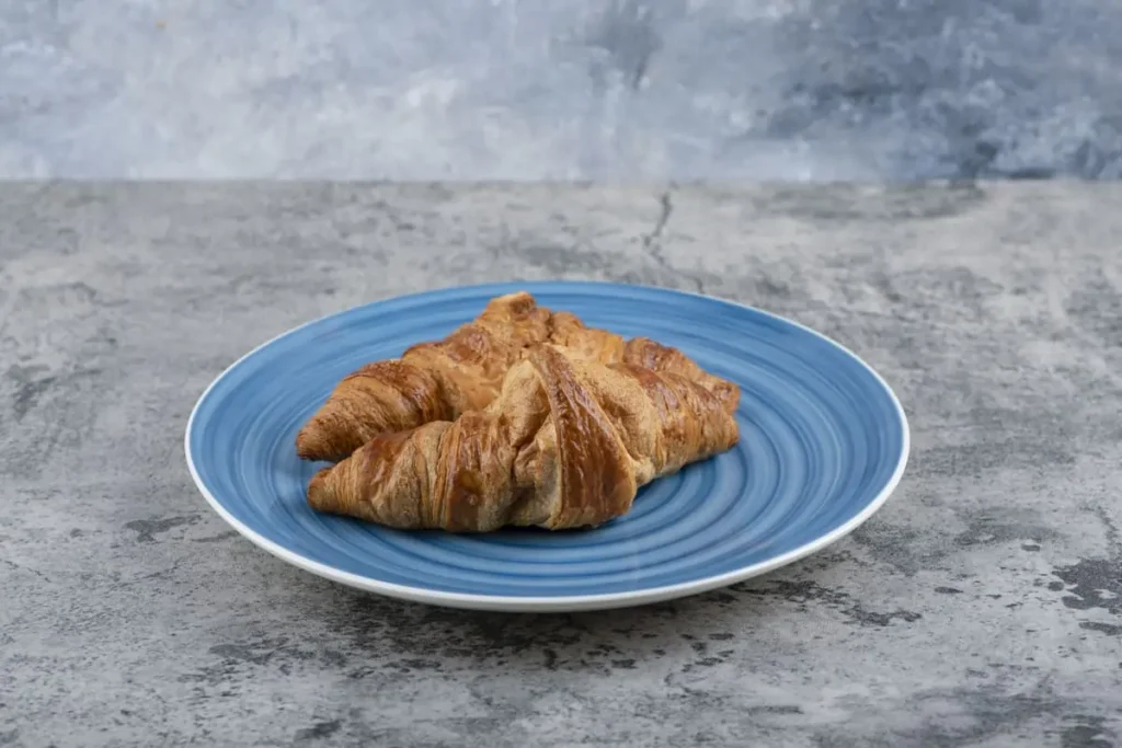 Cookie croissant with gooey filling on a plate.