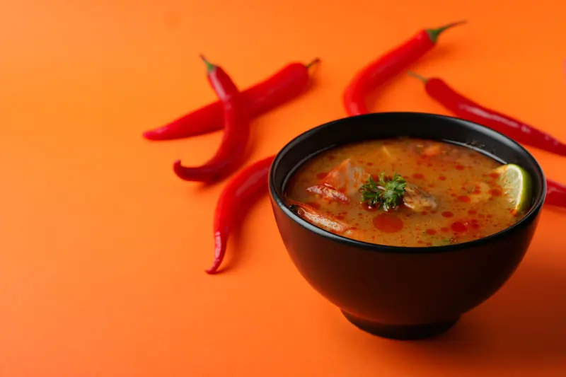 Regular Chili:tasty-tom-yum-soup-orange-background 