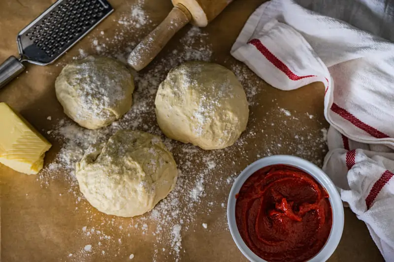 Freshly baked soft and fluffy dinner rolls on a baking tray, golden brown and ready to serve.