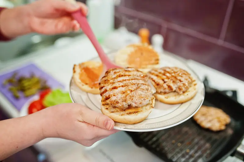 Crispy BBQ Chicken Grilled Cheese sandwich with melted cheese, smoky BBQ chicken, and golden-brown toasted bread on a wooden plate.